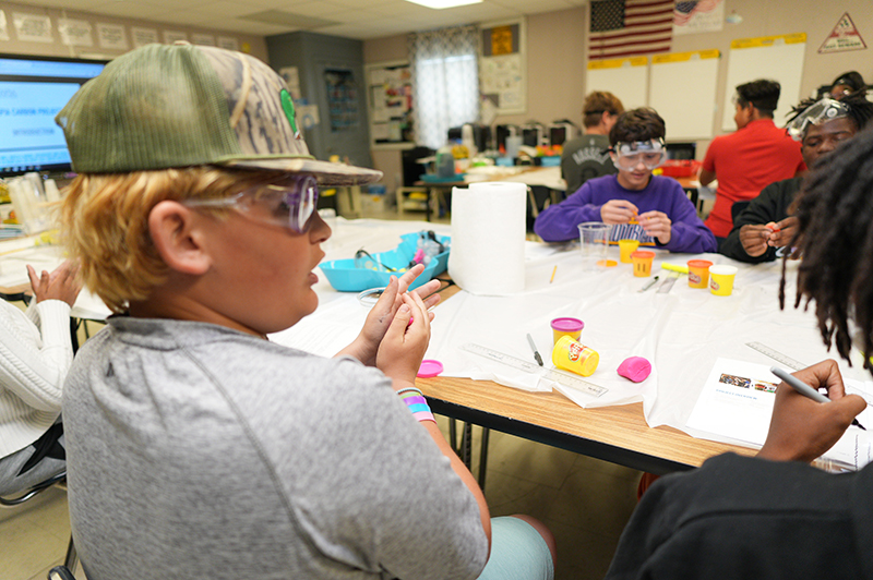 Students building reservoirs