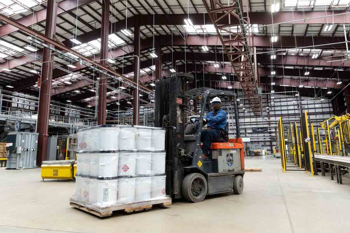 ExxonMobil employee forklifting sanitizer donations